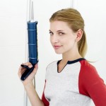 Young Woman Holding a Silicon Applicator Gun Smiling