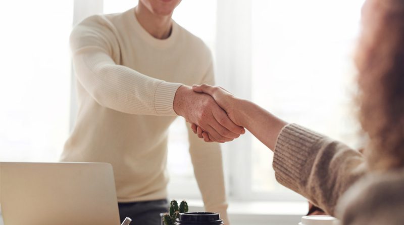 Man and Woman Shaking Hands Over Table 8x6