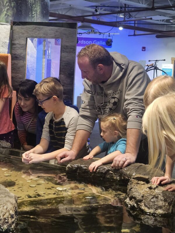family viewing a museum exhibit