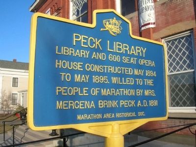 Sign reads: Peck Library library and 600 seat opera house constructed May 1894 to May 1895, willed to the people of Marathon by Mrs. Mercena Brink Peck AD 1891 as per Marathon Historical Society