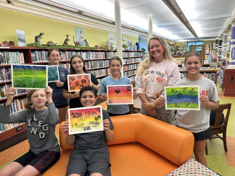 Molly and students show off their art at the library