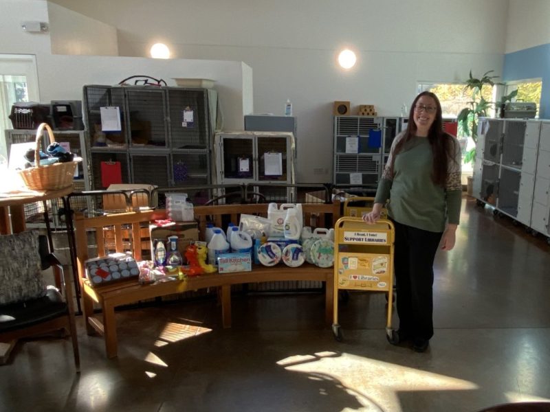 A woman posing with donations for the SPCA